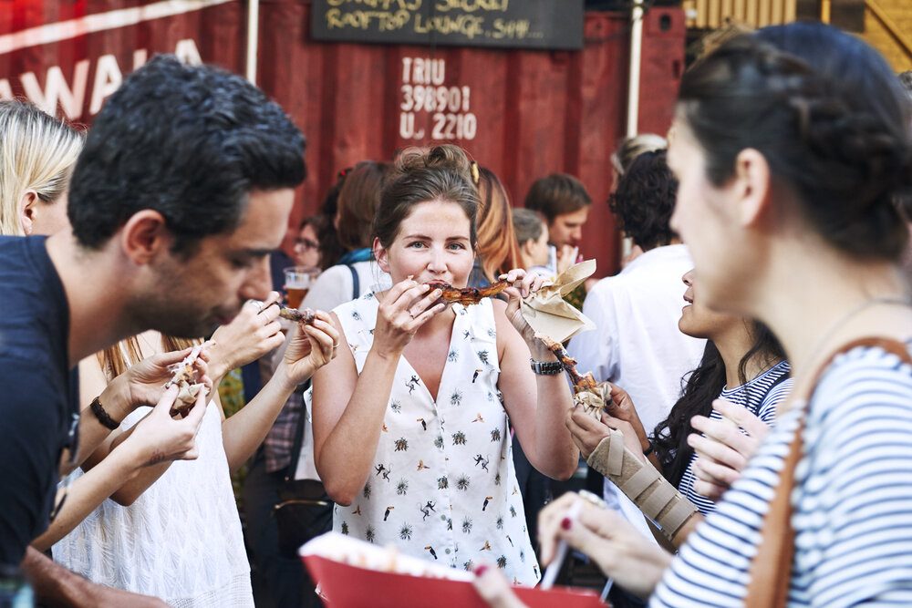 People eating ribs at Street Feast